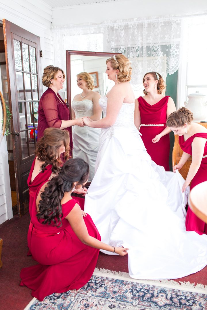 Bridesmaids helping bride get ready