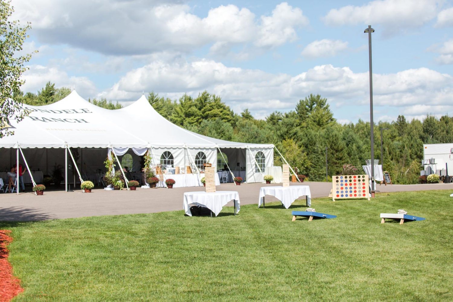 Exterior of Parachute Tent with yard games on the lawn